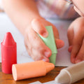 Toddler playing with giant Honeysticks Beeswax crayons